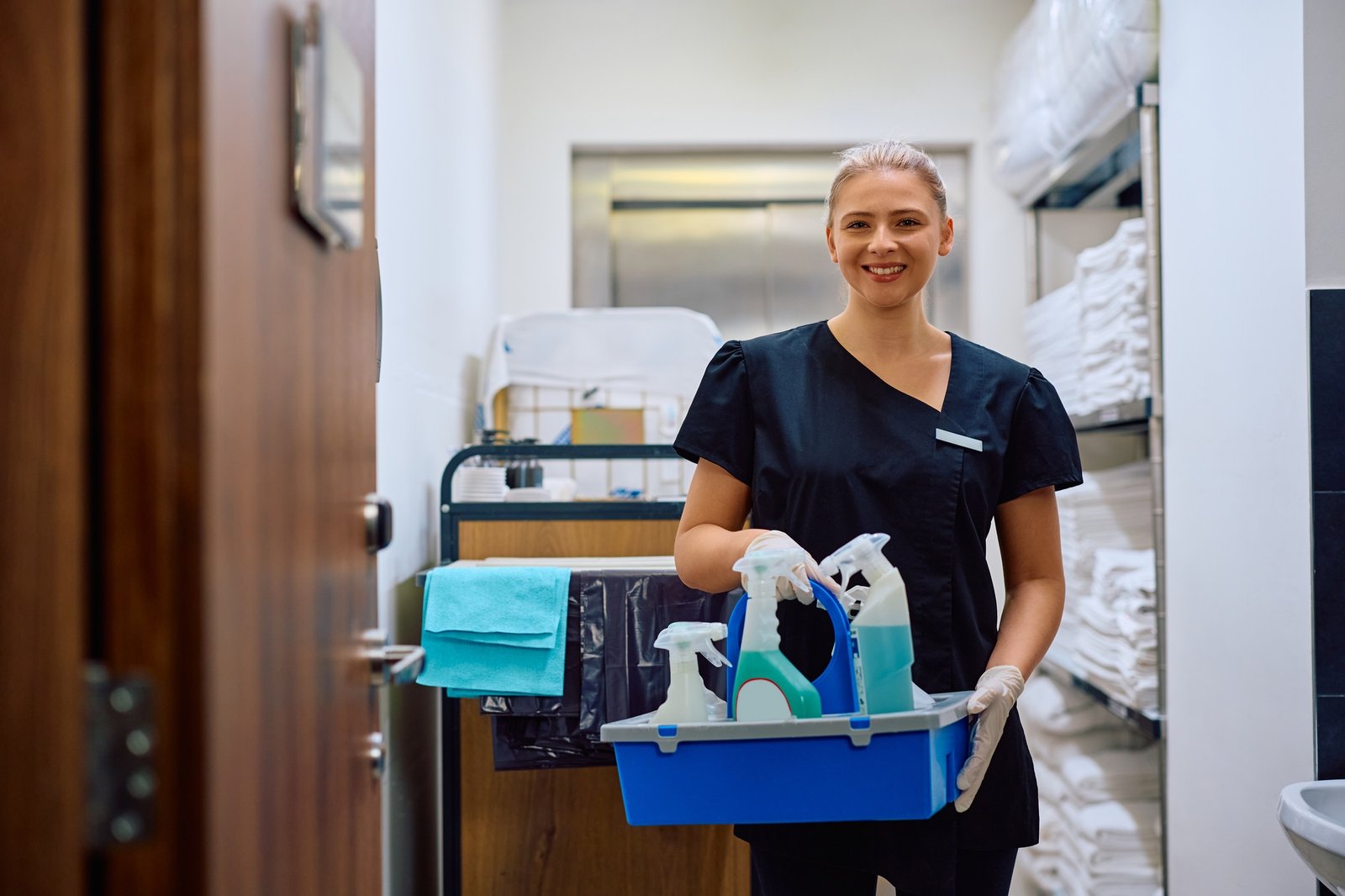 Happy female hotel cleaner looking at camera.
